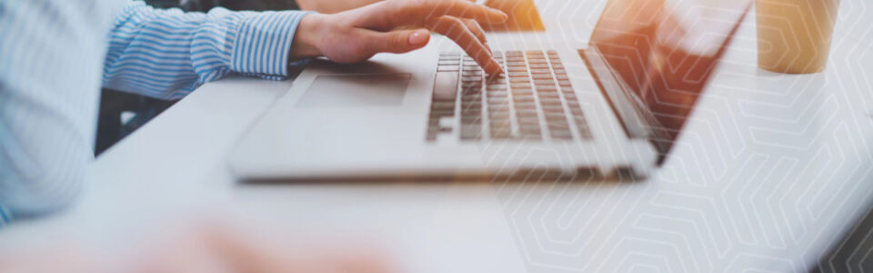 cropped view of female hands typing on a computer using AI in contract automation software