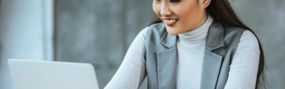 young businesswoman using a contract management tool on laptop in office