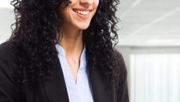 woman using contract negotiation software on laptop computer in office