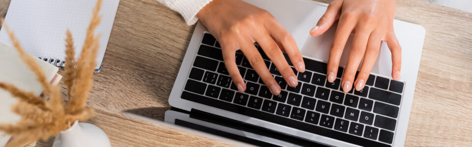 view of businesswoman typing on laptop at home to learn what is CLM software